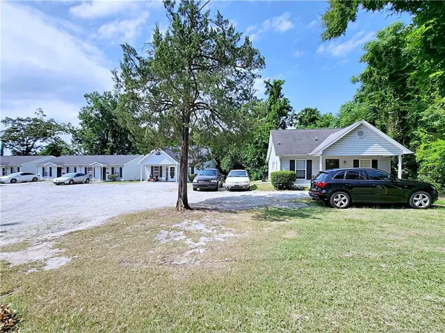 a view of a house with pool and a yard