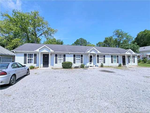 a front view of a house with yard patio and fire pit