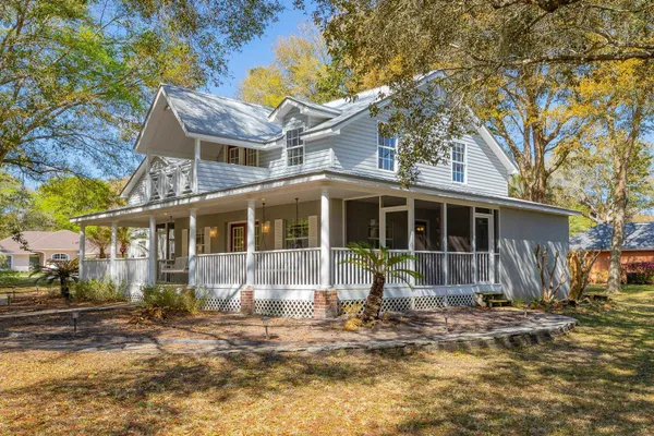 a front view of a house with a yard and glass windows