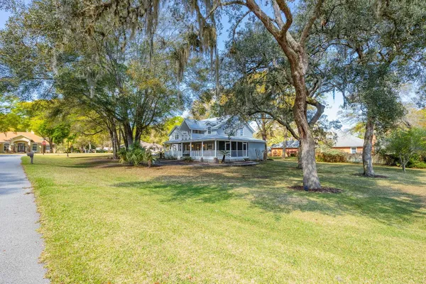 a view of swimming pool with trees in front of house