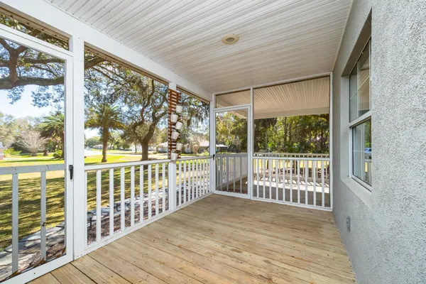 a view of a porch with wooden floor and outdoor space