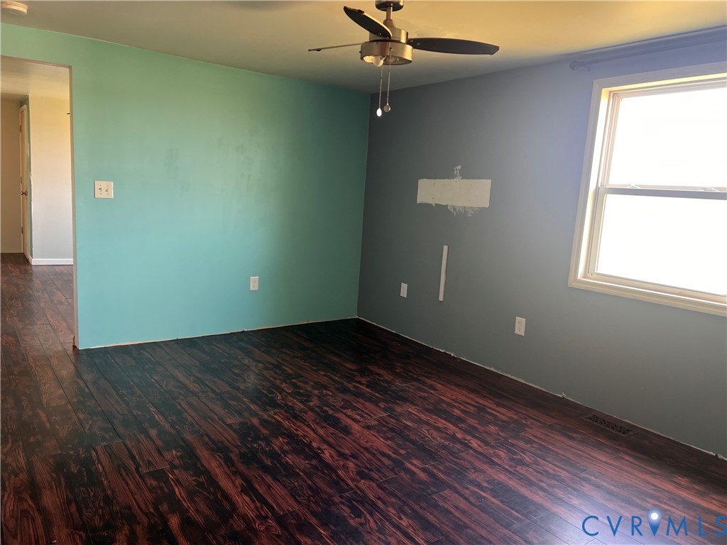 36210 Owens Grove Road Waverly, VA 23890 - Photo 16 of 24 a view of an empty room with wooden floor and a window