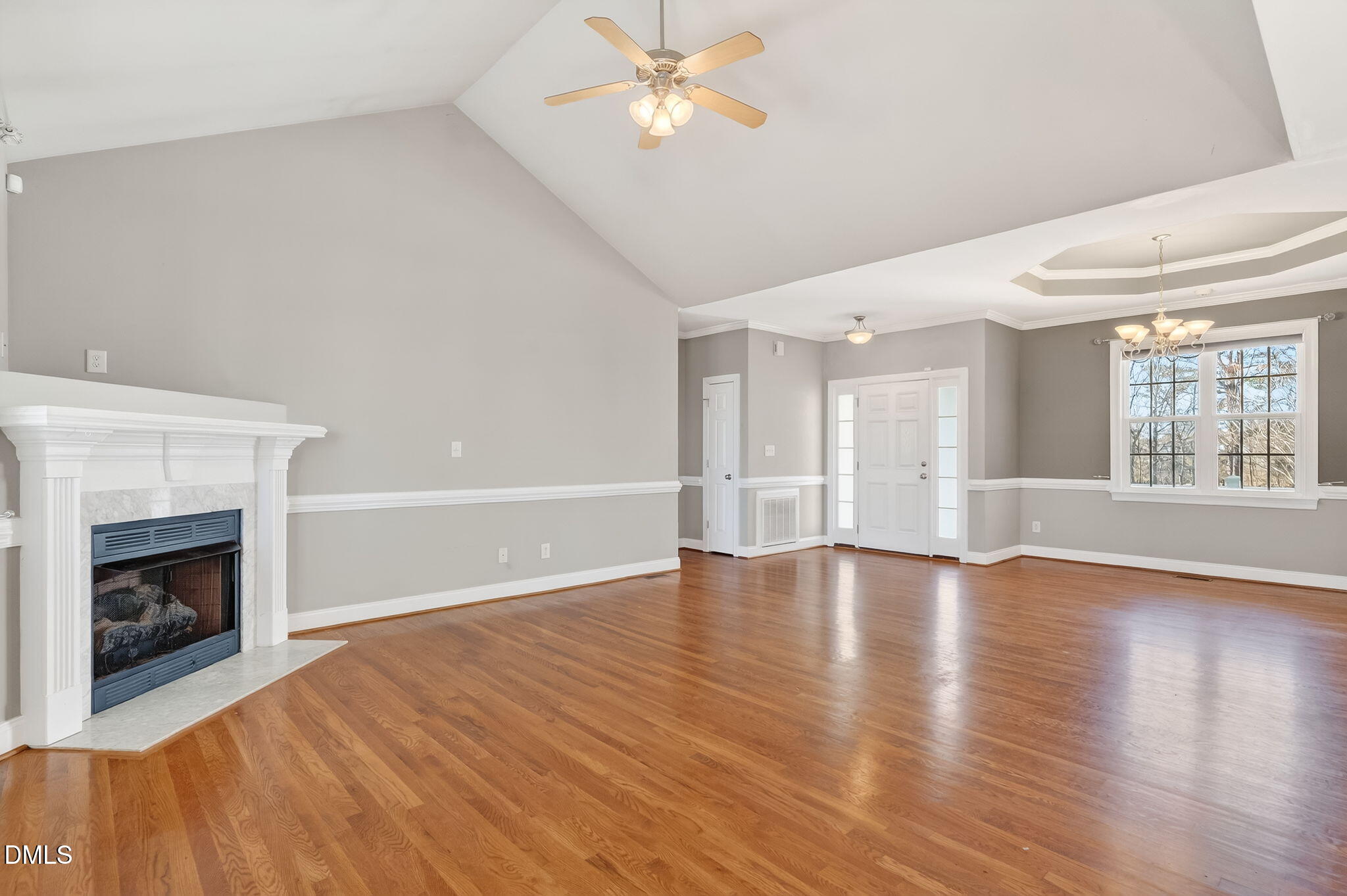 102 Ina Joe Place Willow Spring, NC 27592 - Photo 2 of 23 a view of an empty room with window and wooden floor