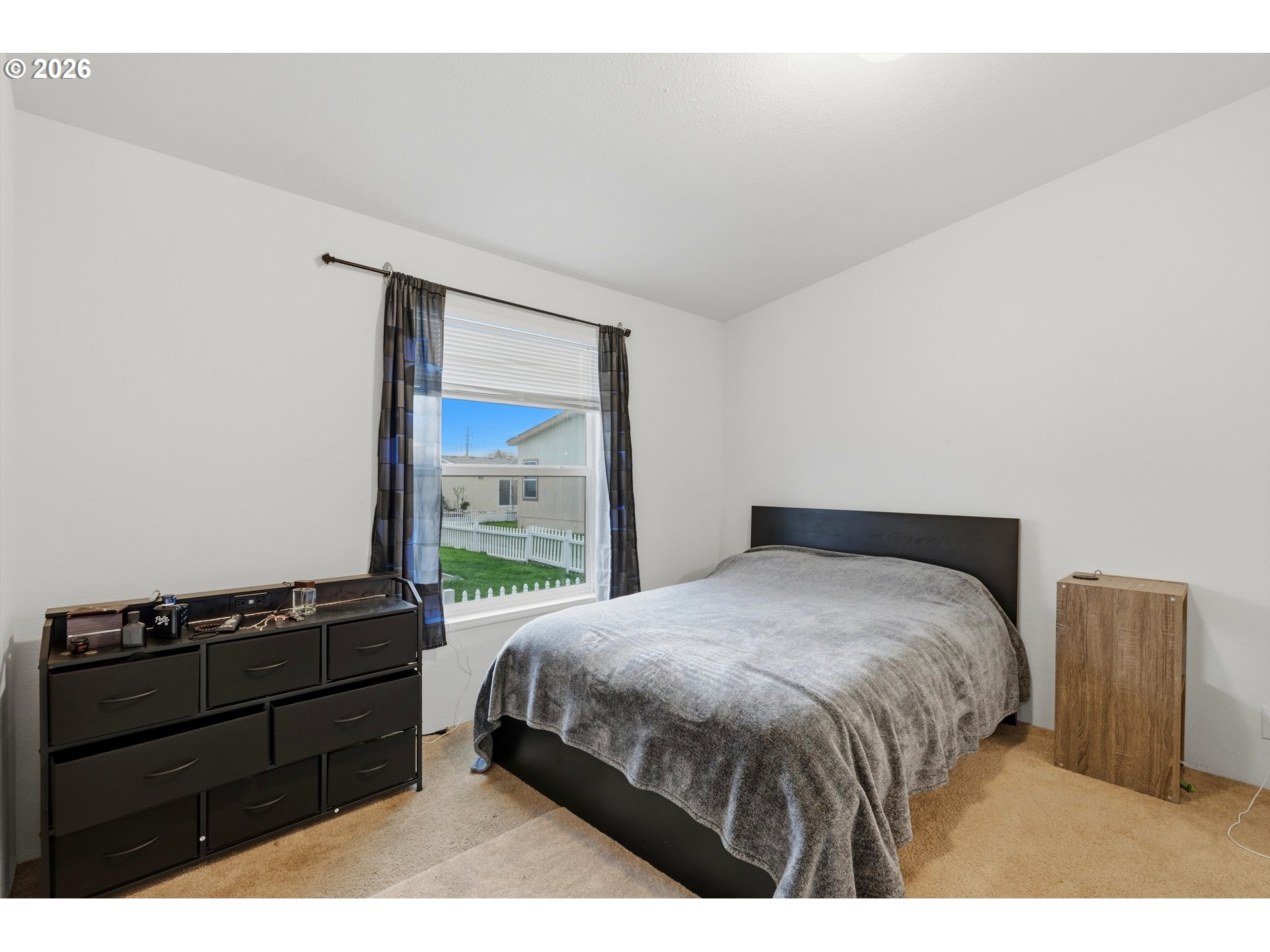 626 Southwest Philadelphia Way, Unit 176 Beaverton, OR 97006 - Photo 18 of 28 a bedroom with a bed and a window