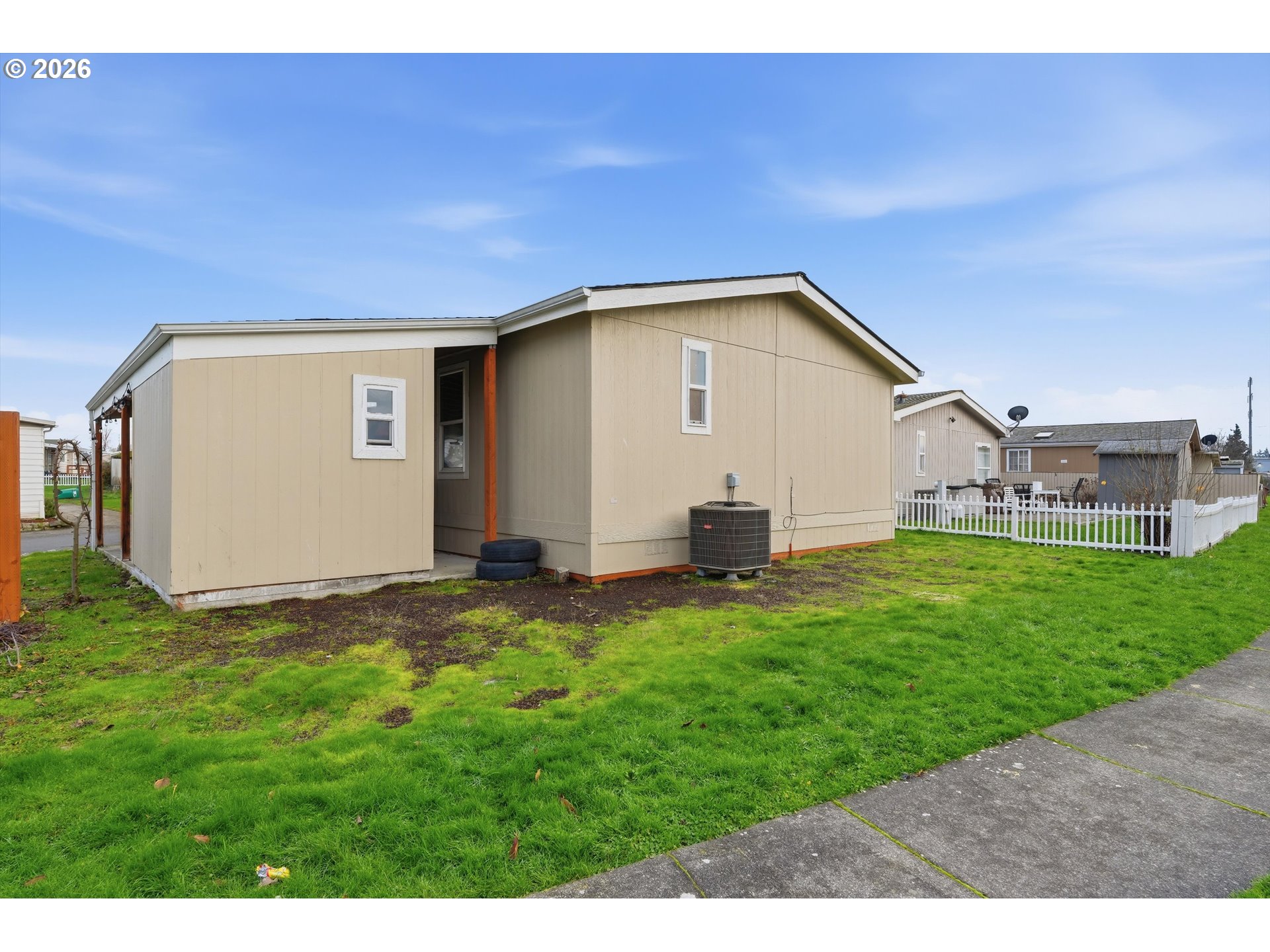 626 Southwest Philadelphia Way, Unit 176 Beaverton, OR 97006 - Photo 27 of 28 a view of a house with a yard