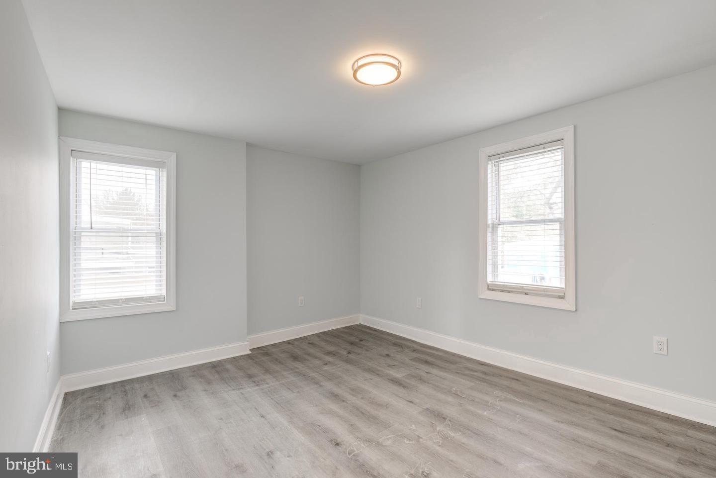 608 9th Street, Unit 2 Chester, PA 19013 - Photo 12 of 13 an empty room with wooden floor and windows