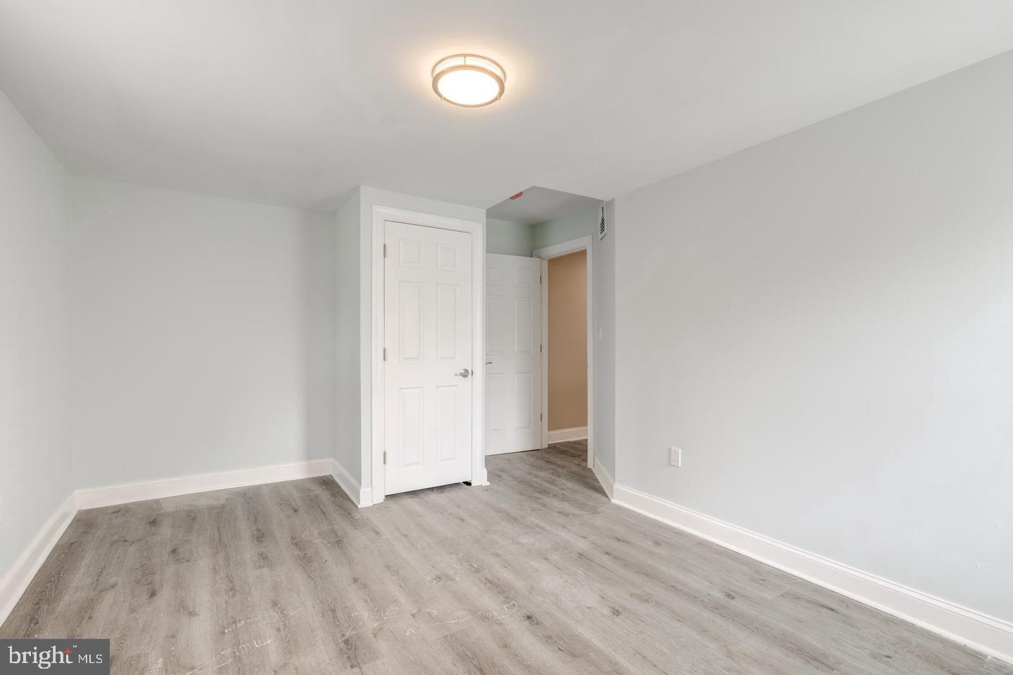 608 9th Street, Unit 2 Chester, PA 19013 - Photo 2 of 13 an empty room with wooden floor and windows