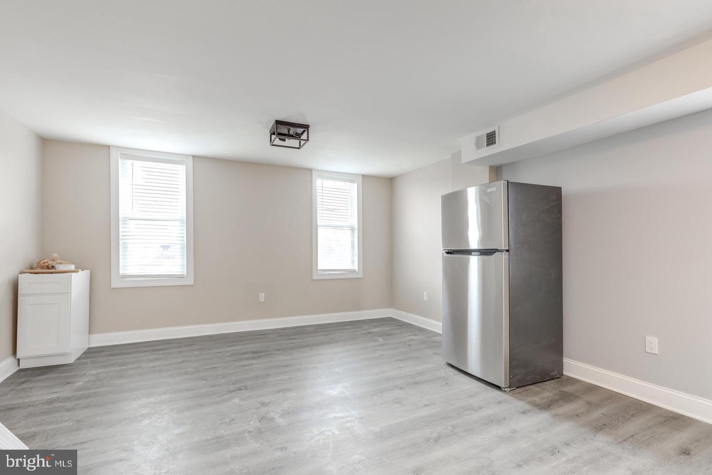 608 9th Street, Unit 2 Chester, PA 19013 - Photo 6 of 13 a view of empty room with wooden floor and window