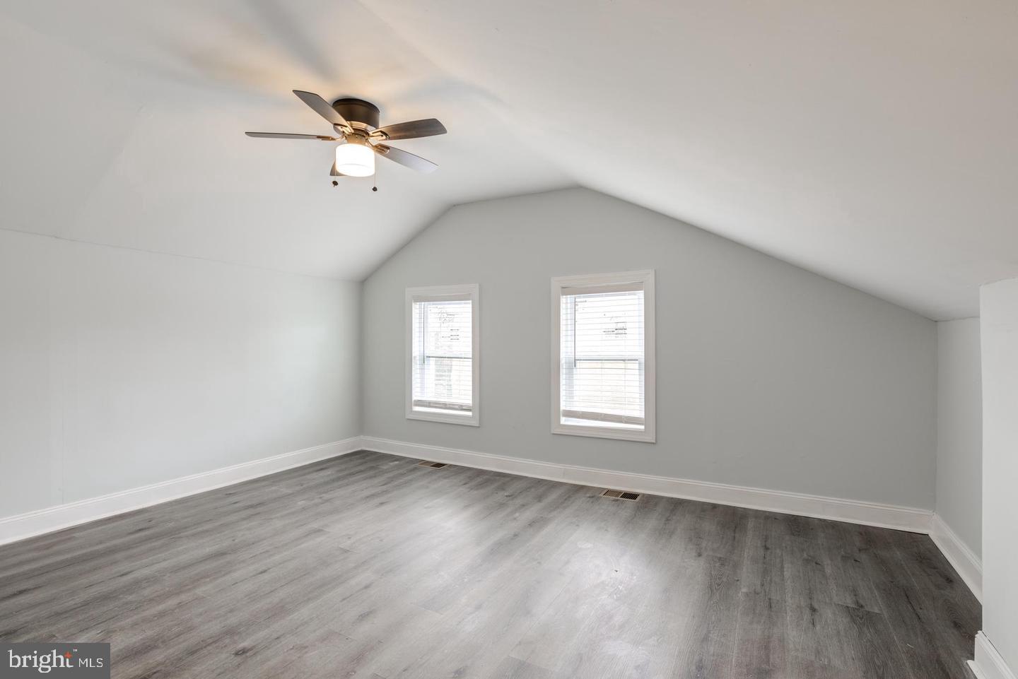 608 9th Street, Unit 2 Chester, PA 19013 - Photo 8 of 13 an empty room with wooden floor fan and windows