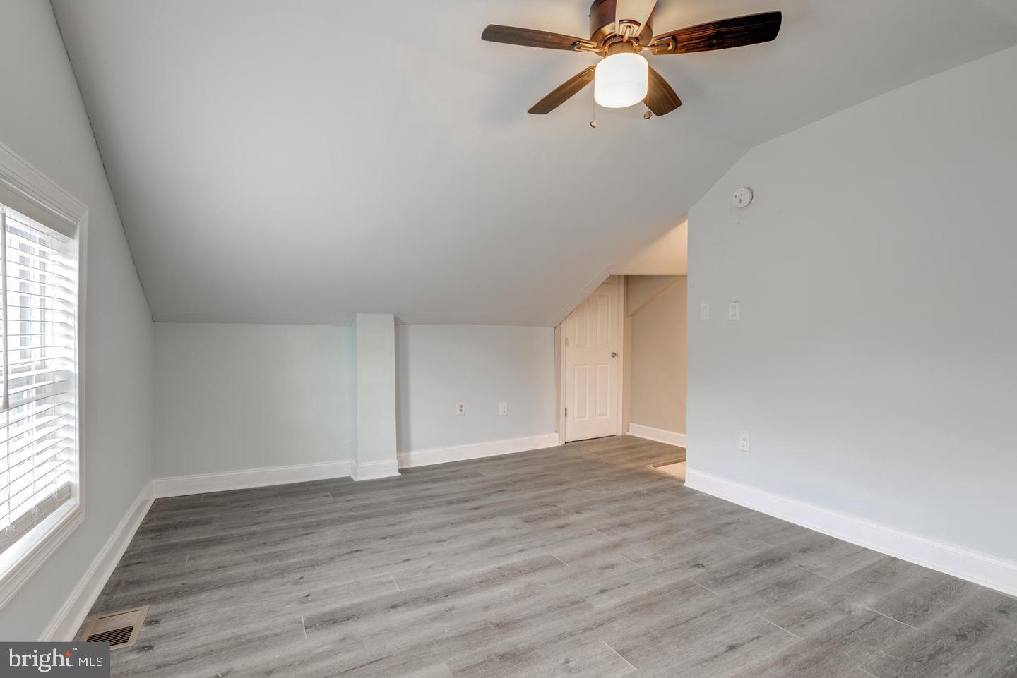 608 9th Street, Unit 2 Chester, PA 19013 - Photo 9 of 13 wooden floor in an empty room with a window