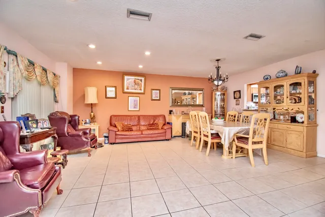 a view of a backyard with a garden and wooden fence