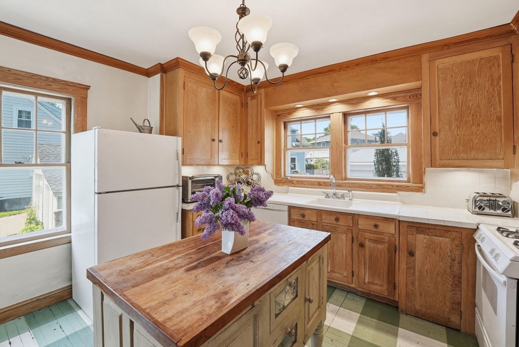19 Humphrey Street Marblehead, MA 01945 - Photo 10 of 29 a kitchen with stainless steel appliances granite countertop a sink refrigerator and microwave