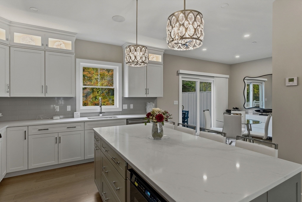 3 Elise Avenue, Unit 95 Londonderry, NH 03053 - Photo 25 of 42 a kitchen with sink cabinets and window