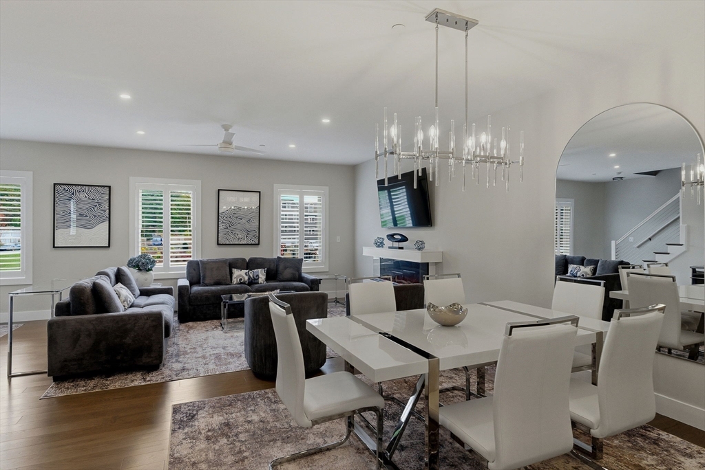 3 Elise Avenue, Unit 95 Londonderry, NH 03053 - Photo 27 of 42 a view of a dining room with furniture a chandelier and wooden floor