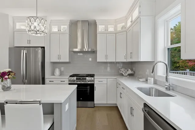 a kitchen with stainless steel appliances granite countertop a sink stove and refrigerator