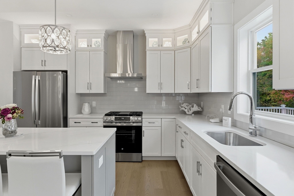 3 Elise Avenue, Unit 95 Londonderry, NH 03053 - Photo 4 of 42 a kitchen with stainless steel appliances granite countertop a sink stove and refrigerator