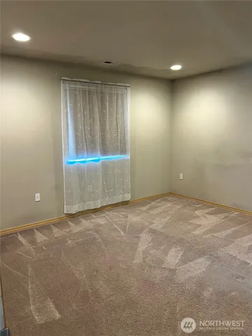 an empty room with a empty space and windows