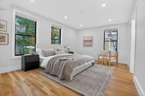 a bedroom with a large bed and a window