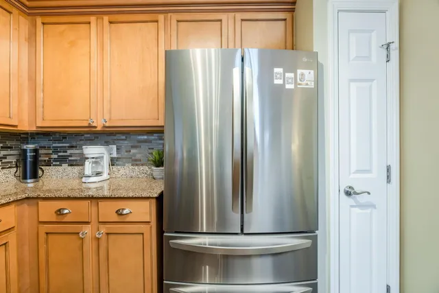 a bedroom with bed and a chandelier