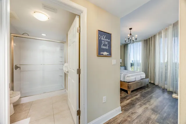 a spacious bedroom with a bed and a flat screen tv