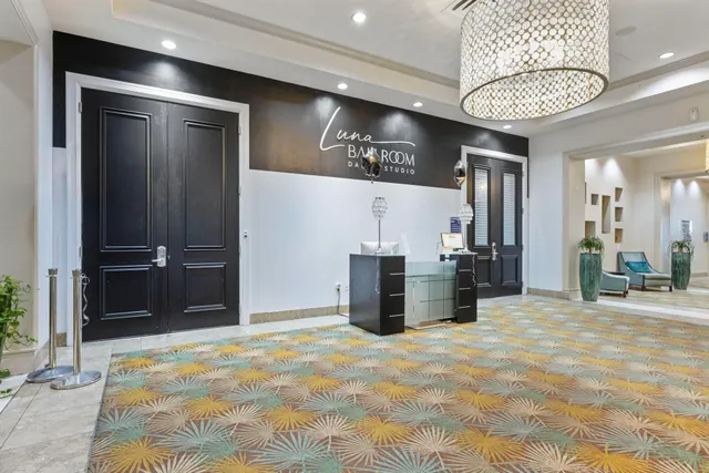 a living room with furniture kitchen view and a flat screen tv