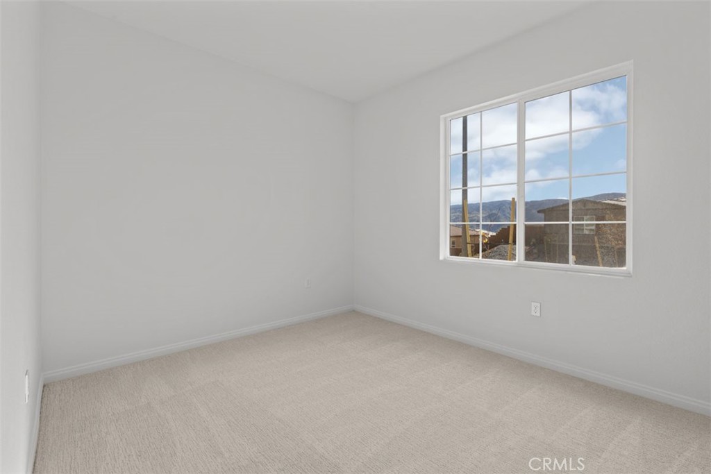 1249 Butterfly Way Banning, CA 92220 - Photo 5 of 18 an empty room with a window