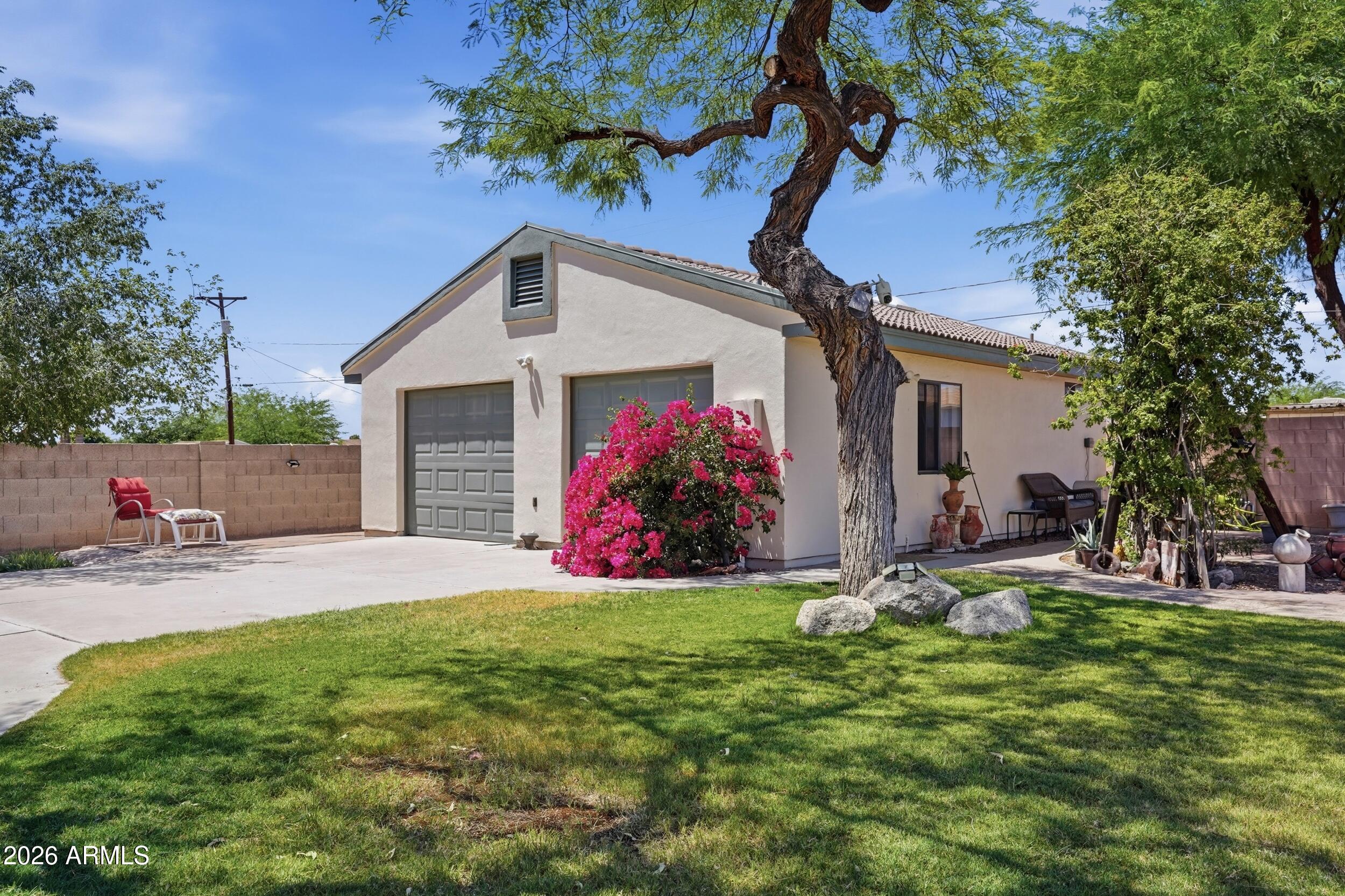 6334 East Albany Street Mesa, AZ 85205 - Photo 47 of 72 a view of a house with a yard and sitting area