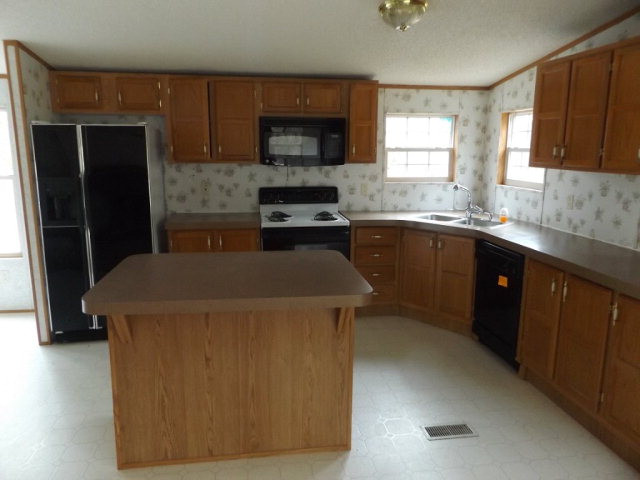 279 Migrant Camp Road Batesburg, SC 29006 - Photo 6 of 19 a kitchen with a sink a stove and refrigerator