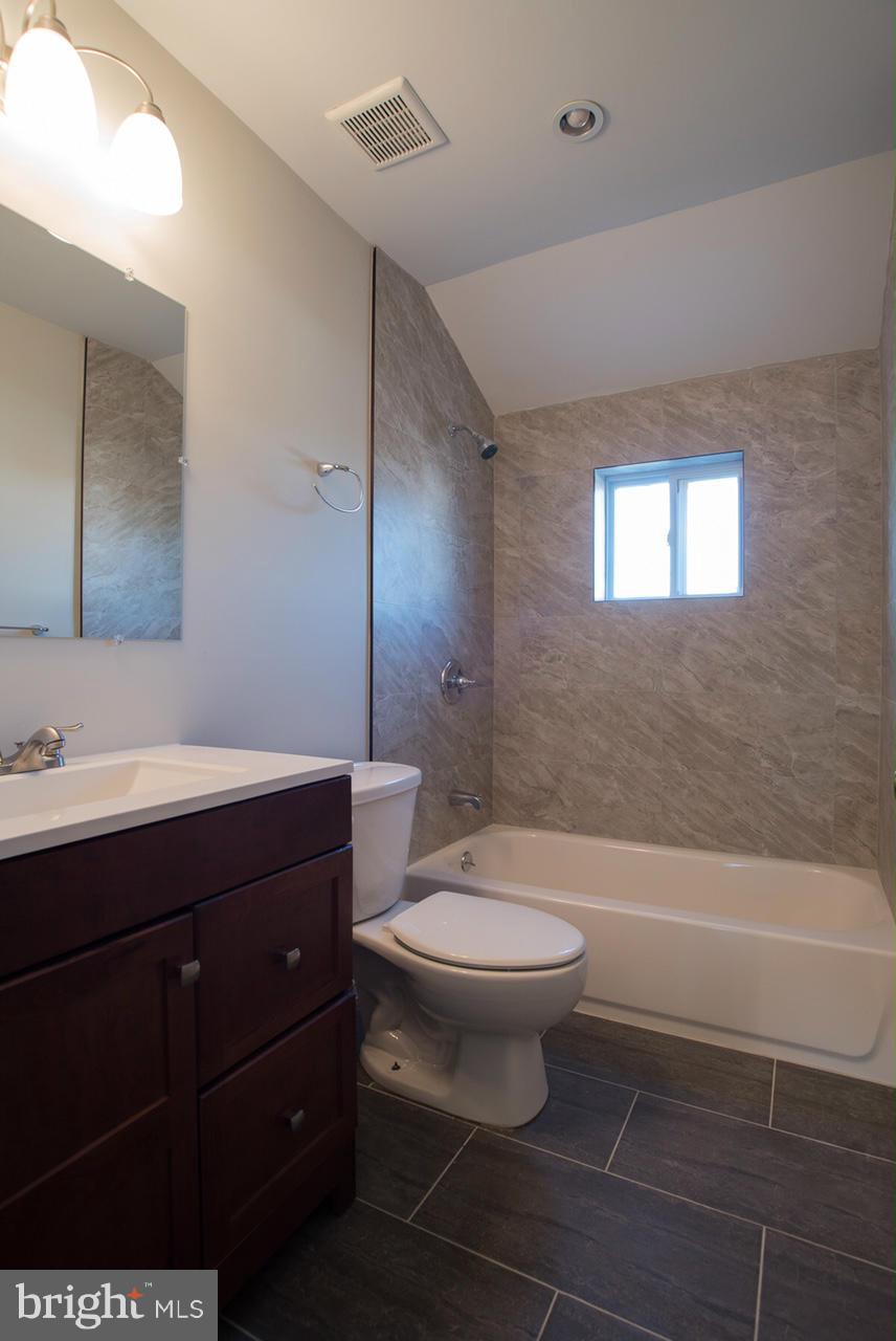450 Torner Road Baltimore, MD 21221 - Photo 6 of 10 a bathroom with a sink a toilet and shower