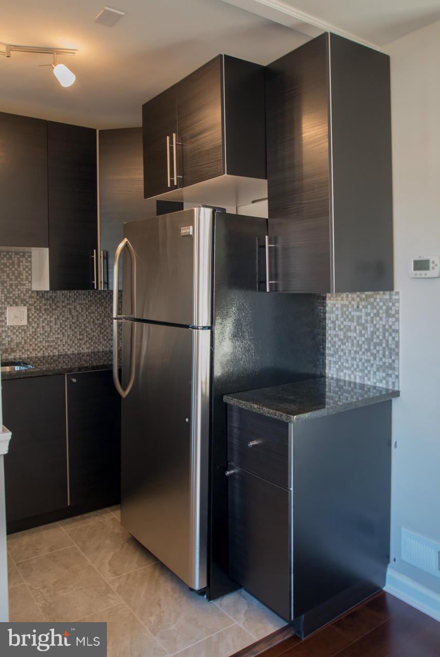 450 Torner Road Baltimore, MD 21221 - Photo 8 of 10 a kitchen with stainless steel appliances granite countertop a refrigerator and a sink