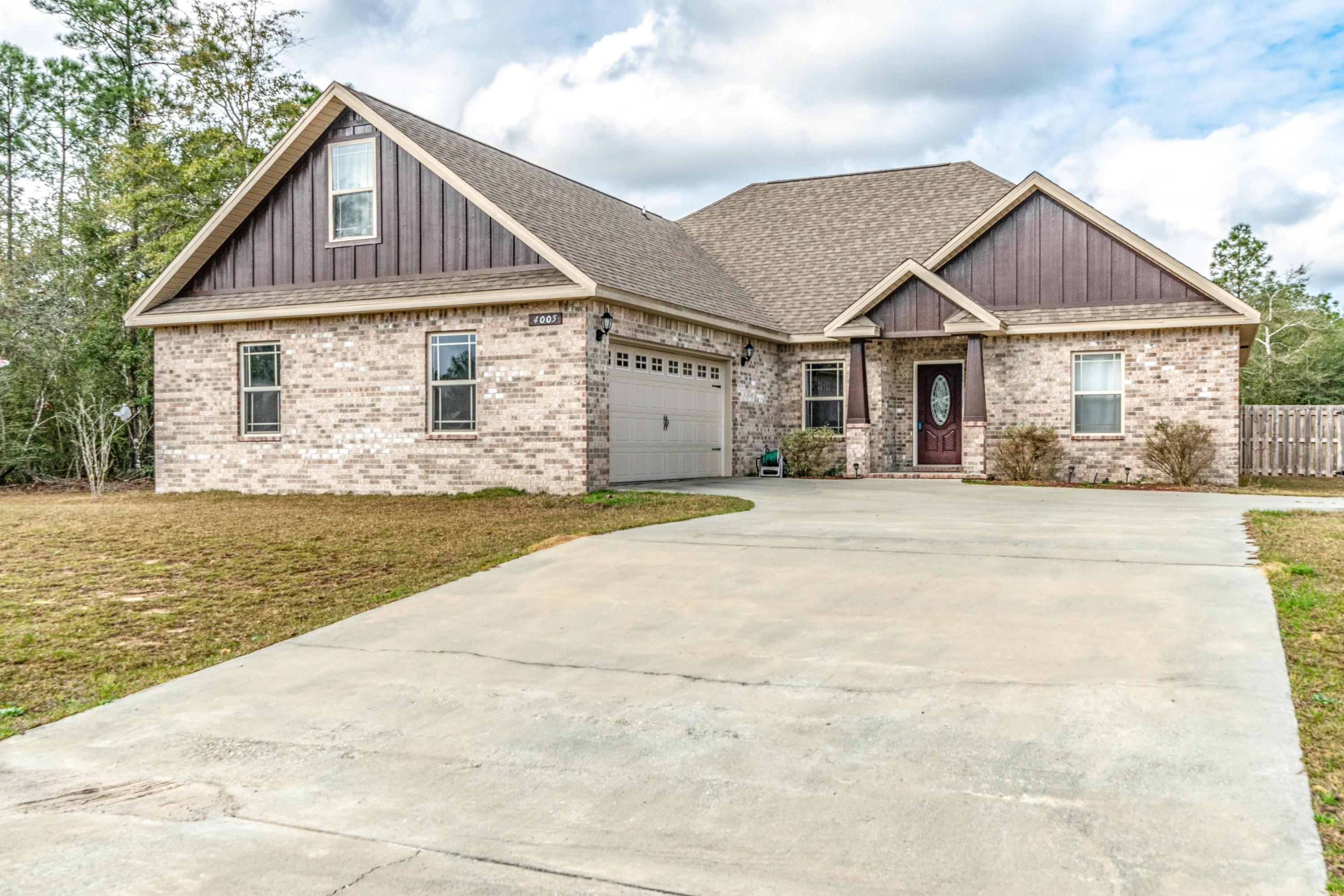 4005 Happy Trails Road Crestview, FL 32539 - Photo 1 of 24 a front view of a house with a yard