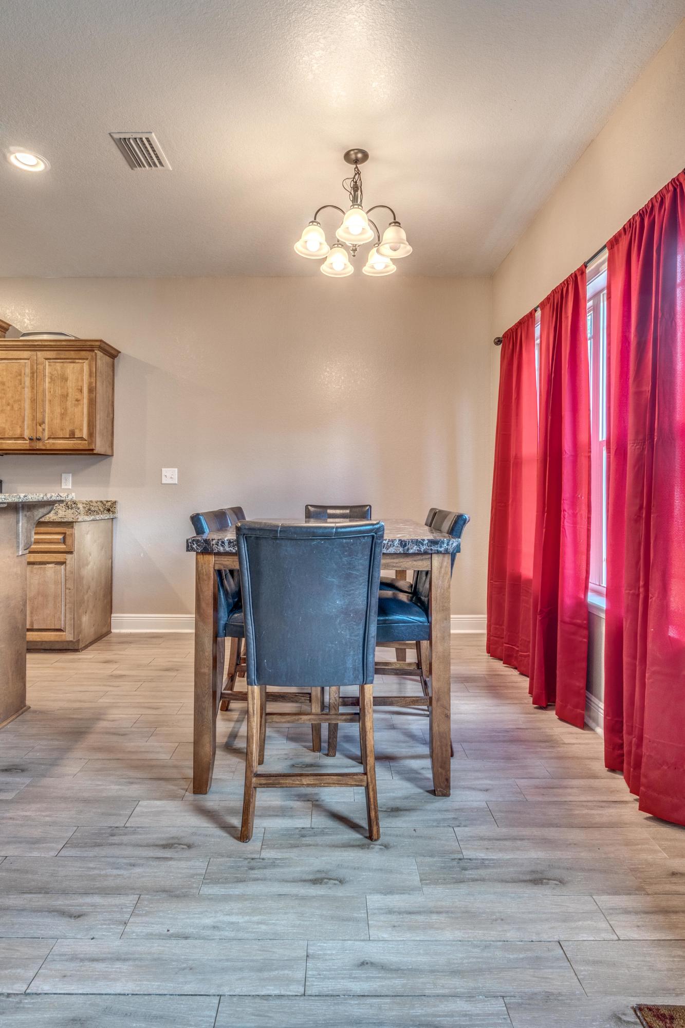 4005 Happy Trails Road Crestview, FL 32539 - Photo 11 of 24 a view of a dining room with furniture and chandelier