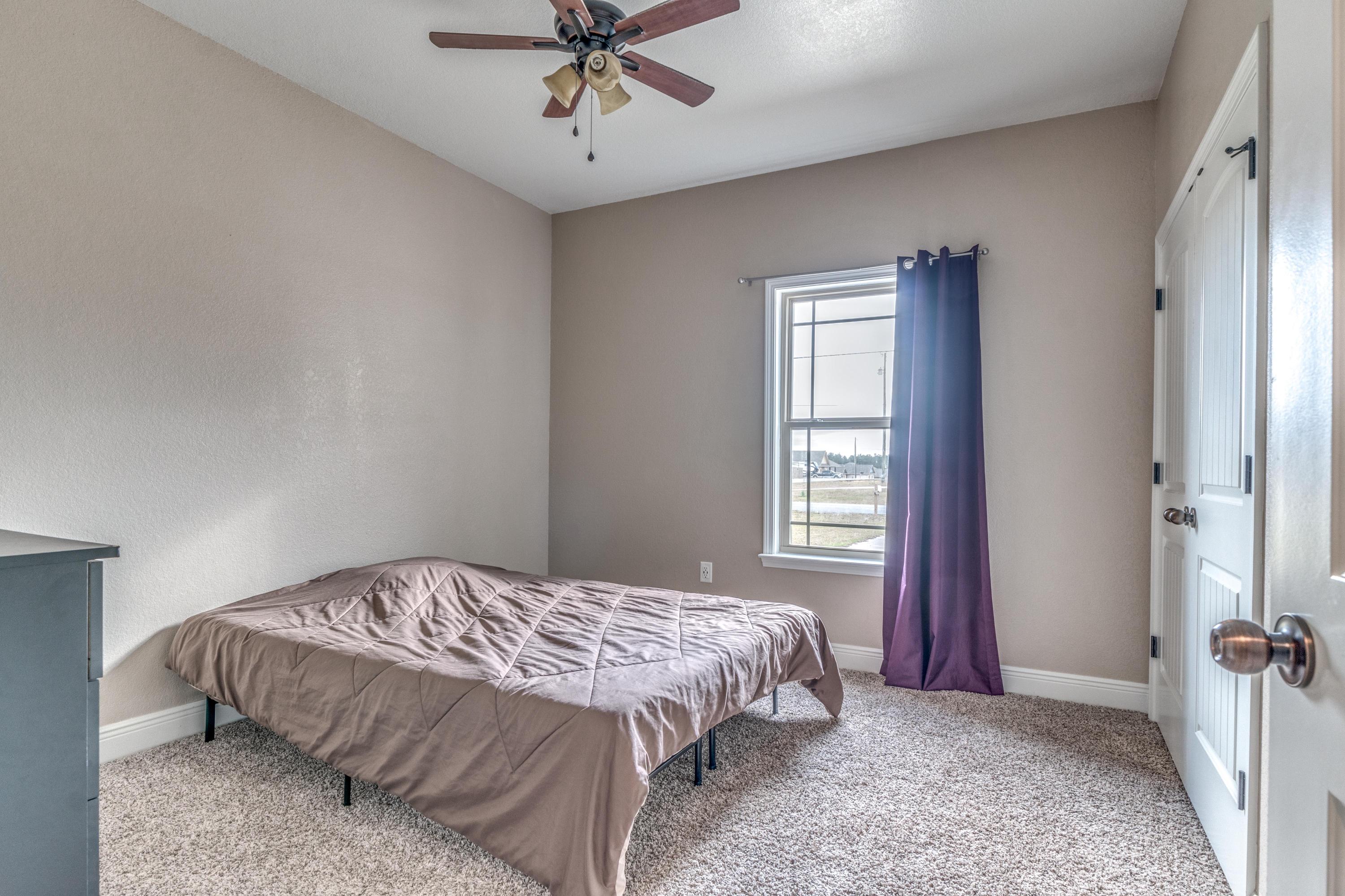4005 Happy Trails Road Crestview, FL 32539 - Photo 15 of 24 a bedroom with a bed and a chandelier
