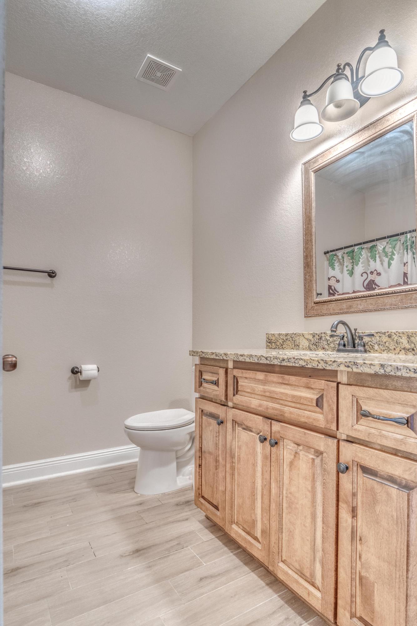 4005 Happy Trails Road Crestview, FL 32539 - Photo 18 of 24 a bathroom with a granite countertop toilet sink and mirror