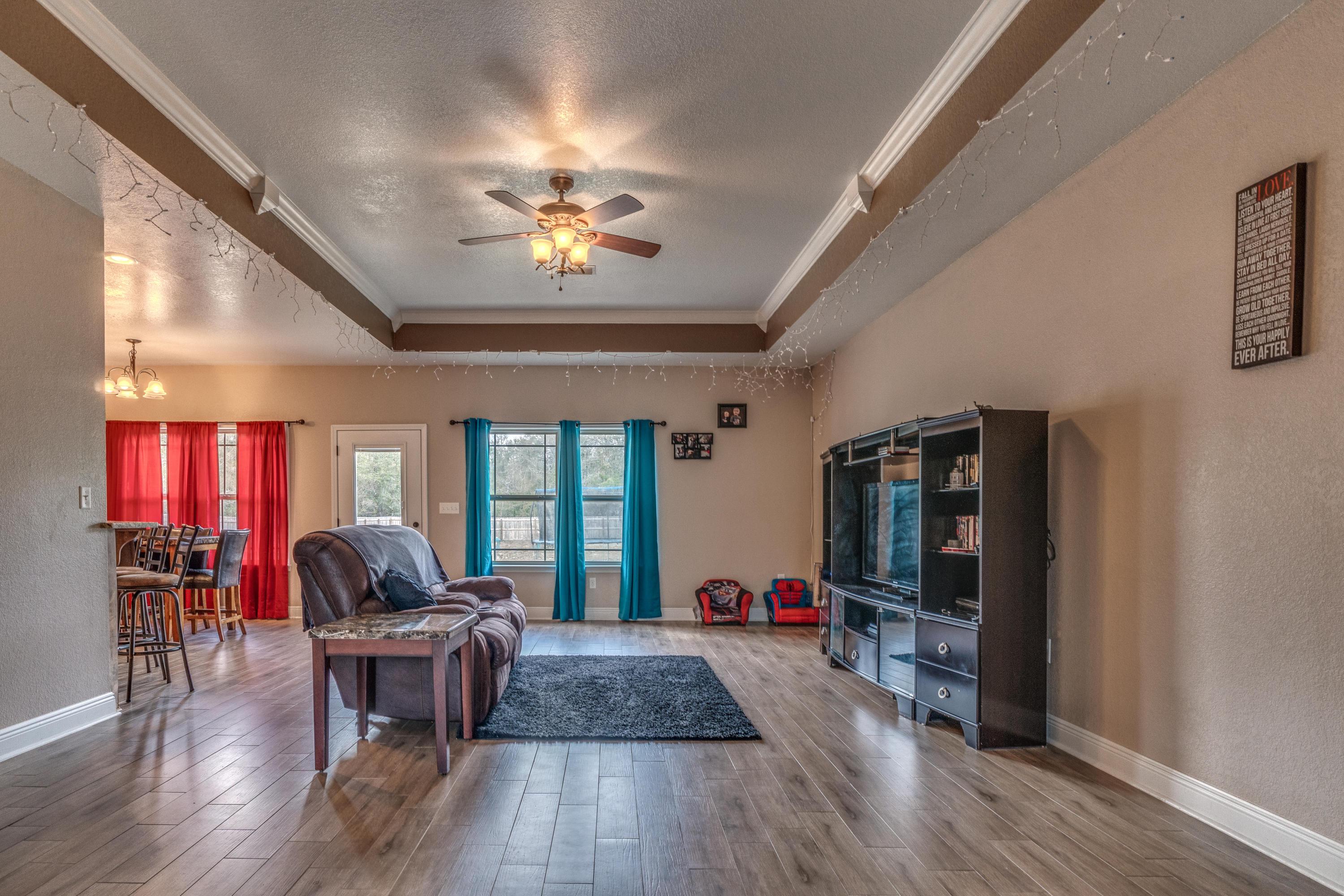 4005 Happy Trails Road Crestview, FL 32539 - Photo 2 of 24 a living room with furniture and a wooden floor