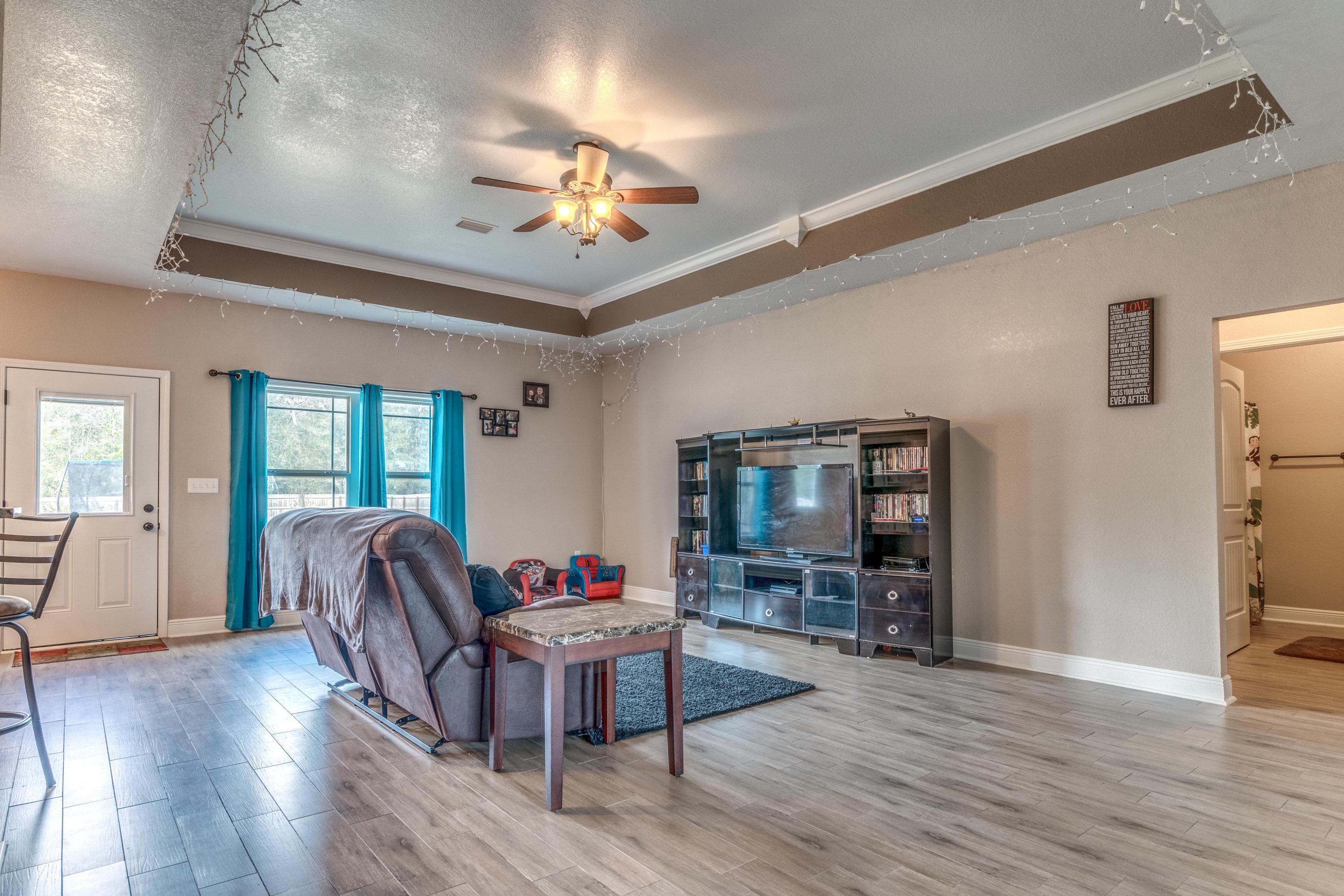 4005 Happy Trails Road Crestview, FL 32539 - Photo 3 of 24 a living room with furniture and a flat screen tv