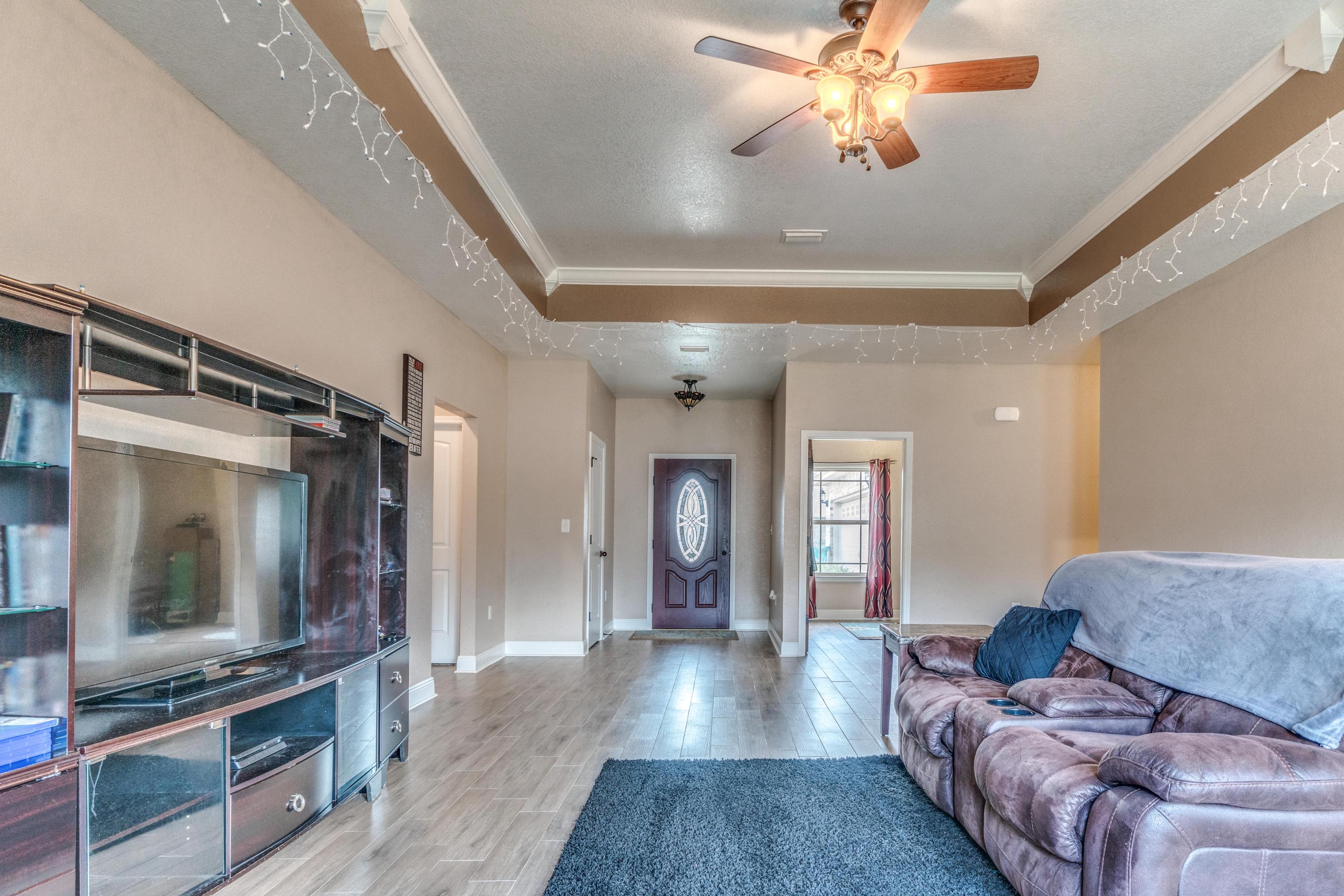 4005 Happy Trails Road Crestview, FL 32539 - Photo 5 of 24 a living room with furniture and a flat screen tv