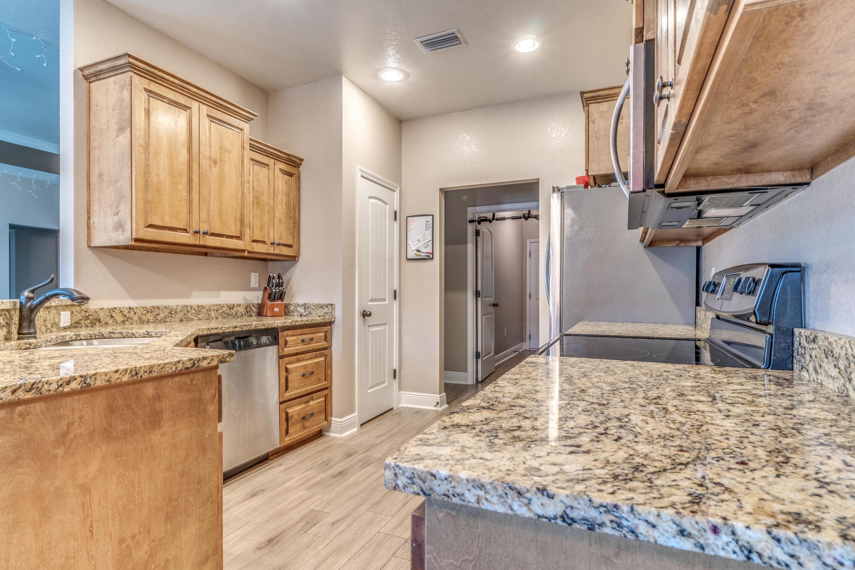 4005 Happy Trails Road Crestview, FL 32539 - Photo 6 of 24 a kitchen with stainless steel appliances granite countertop a stove a sink and a refrigerator