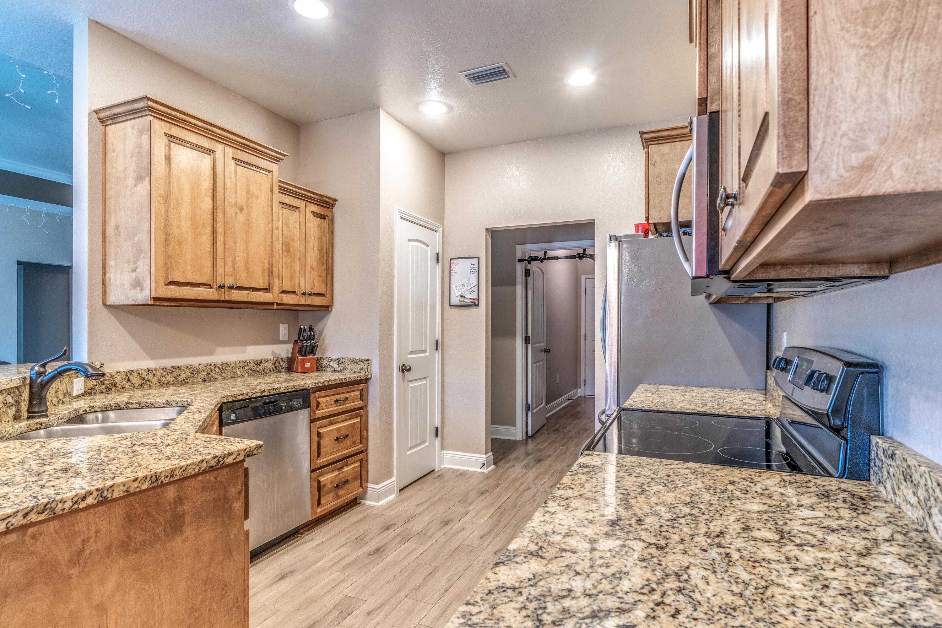 4005 Happy Trails Road Crestview, FL 32539 - Photo 7 of 24 a kitchen with stainless steel appliances granite countertop a sink stove and refrigerator