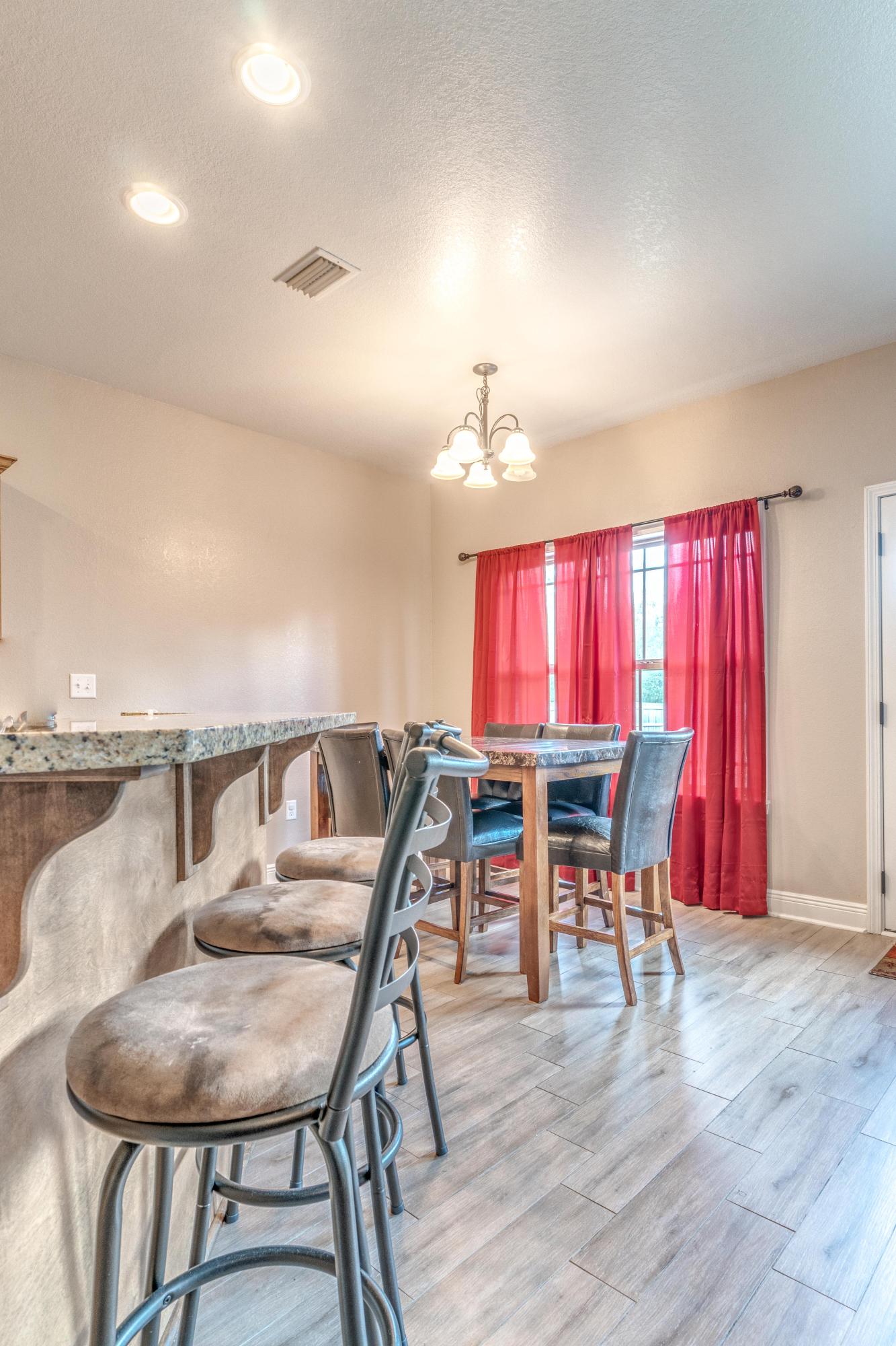 4005 Happy Trails Road Crestview, FL 32539 - Photo 10 of 24 a view of a dining room with furniture and wooden floor
