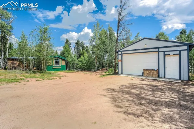 a view of a house with a yard and garage