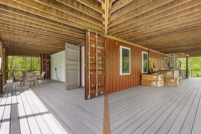 a living room with furniture and a floor to ceiling window