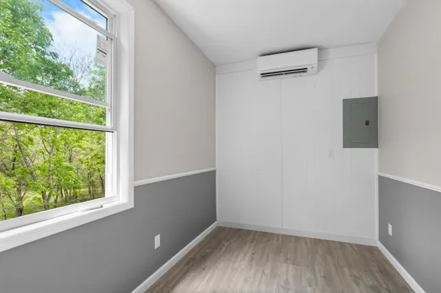 wooden floor in an empty room with a window and wooden floor