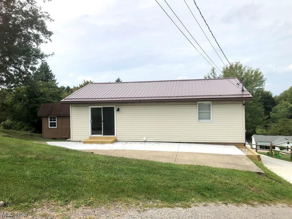 756 Northview Road Wellsburg, WV 26070 - Photo 24 of 25 Rear view of house with an outdoor structure and a lawn