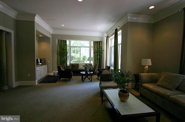 851 North Glebe Road, Unit 810 Arlington, VA 22203 - Photo 12 of 28 a living room with furniture and large windows