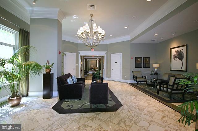 851 North Glebe Road, Unit 810 Arlington, VA 22203 - Photo 4 of 28 a living room with furniture potted plant and a chandelier