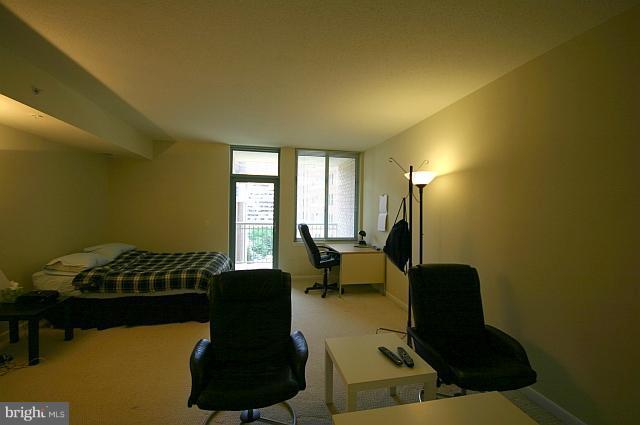 851 North Glebe Road, Unit 810 Arlington, VA 22203 - Photo 7 of 28 a living room with furniture and a window