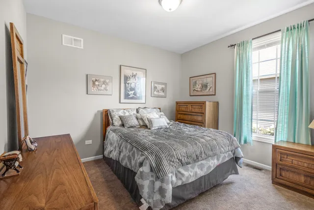 a bedroom with a bed and a dresser