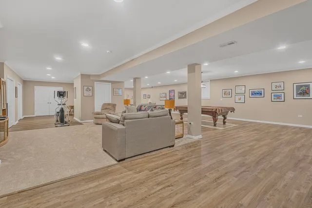 a living room with furniture wooden floor and a table
