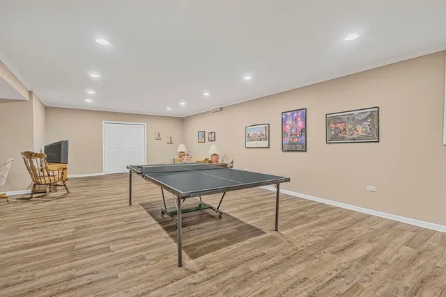 a room with furniture pool table and wooden floor